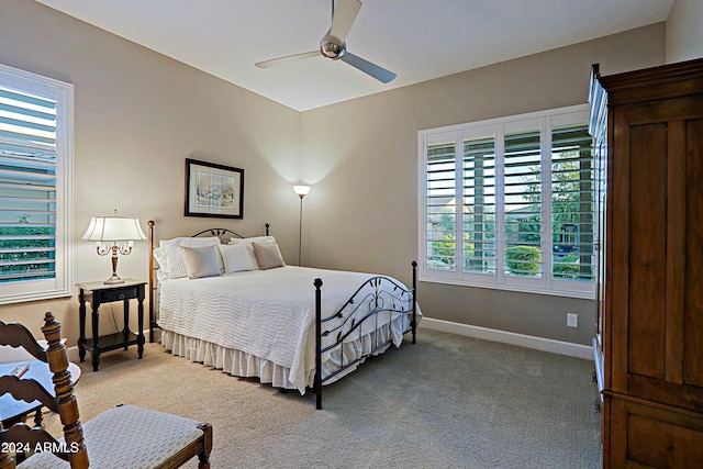 bedroom featuring carpet floors, multiple windows, and ceiling fan