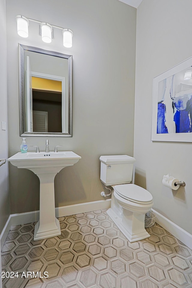 bathroom featuring tile patterned floors, sink, and toilet