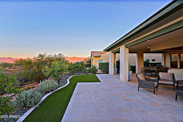 view of patio terrace at dusk