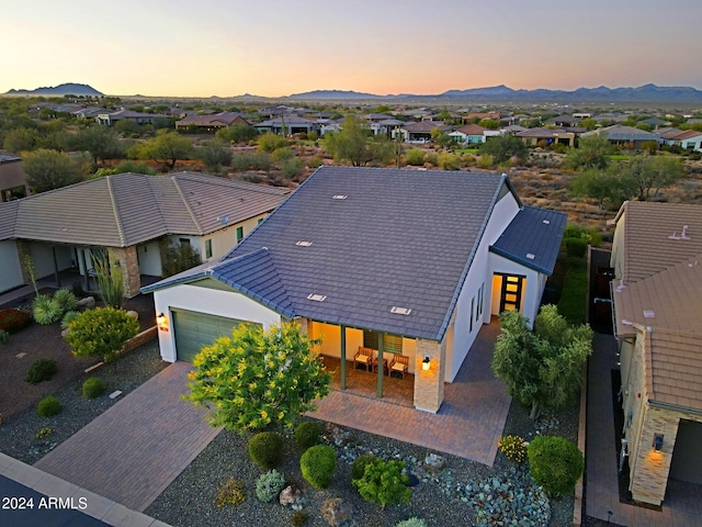 aerial view at dusk featuring a mountain view