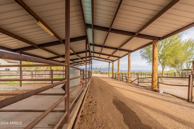 view of horse barn with a rural view