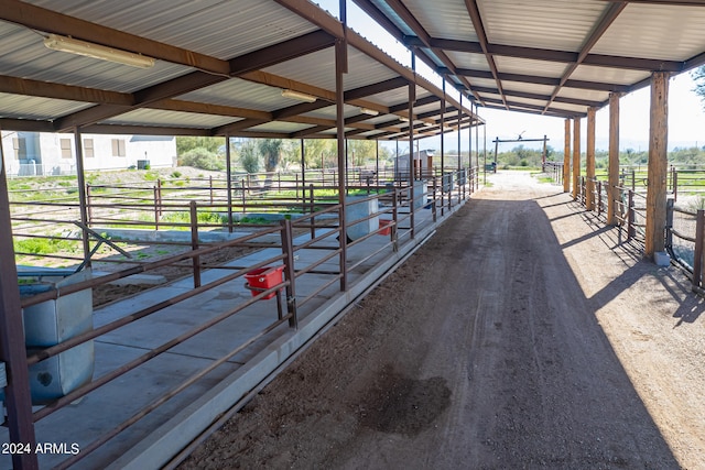 view of horse barn featuring a rural view