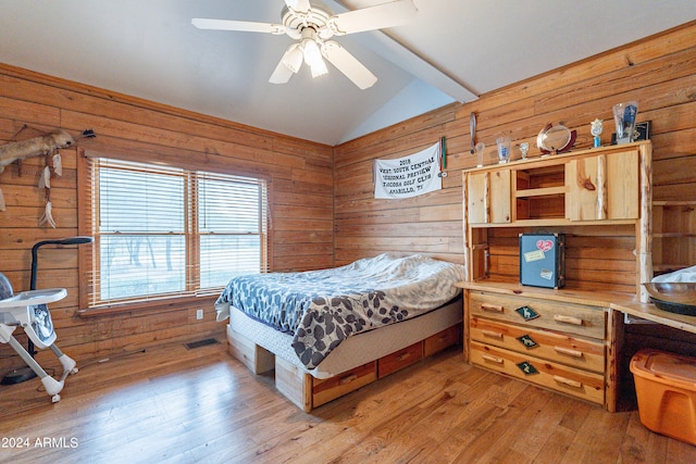 bedroom with vaulted ceiling with beams, ceiling fan, light hardwood / wood-style flooring, and wood walls