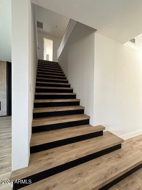 stairway featuring wood-type flooring