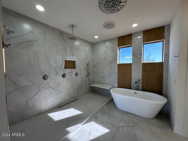 bathroom featuring shower with separate bathtub