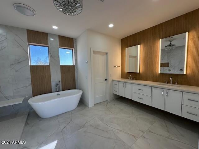 bathroom featuring wooden walls, a bathtub, and vanity