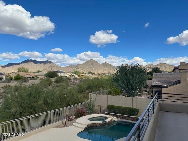 view of swimming pool featuring an in ground hot tub and a mountain view