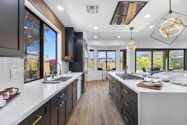 10646 E Butherus Dr, Scottsdale, AZ 85255 - kitchen featuring a sink, appliances with stainless steel finishes, light wood-style floors, light countertops, and recessed lighting