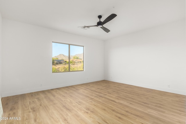 spare room featuring ceiling fan and light hardwood / wood-style flooring