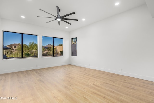 unfurnished room with ceiling fan and light hardwood / wood-style floors