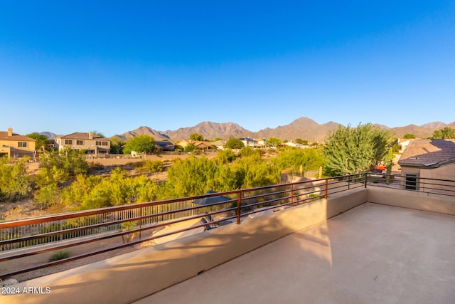 view of patio with a mountain view and a balcony