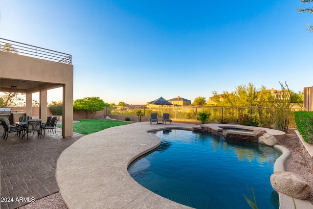 view of swimming pool with an in ground hot tub and a patio