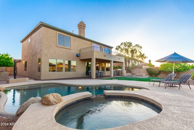 view of pool featuring a patio area and an in ground hot tub