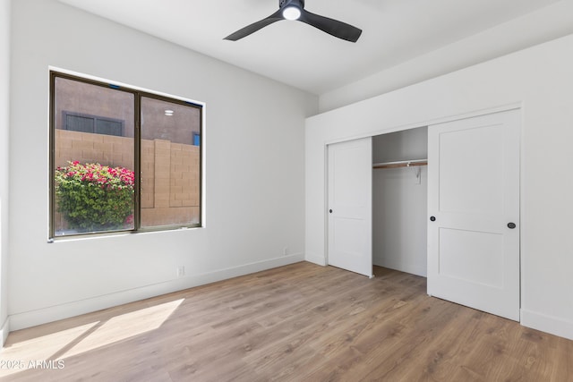 10646 E Butherus Dr, Scottsdale, AZ 85255 - unfurnished bedroom with wood finished floors, a closet, baseboards, and a ceiling fan