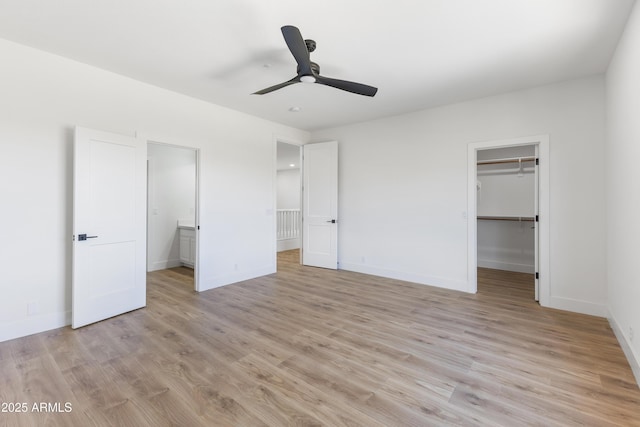 10646 E Butherus Dr, Scottsdale, AZ 85255 - unfurnished bedroom with a spacious closet, light wood-style flooring, baseboards, and a closet