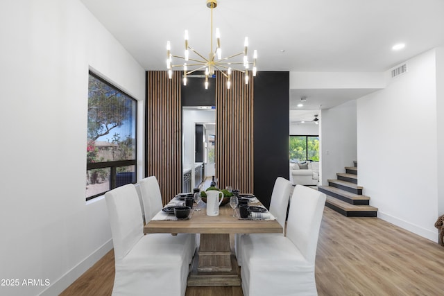 10646 E Butherus Dr, Scottsdale, AZ 85255 - dining room featuring a chandelier, wood finished floors, baseboards, recessed lighting, and stairs