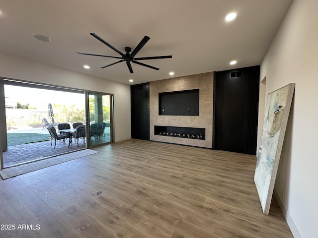 10646 E Butherus Dr, Scottsdale, AZ 85255 - living area with a ceiling fan, a tiled fireplace, baseboards, wood finished floors, and recessed lighting