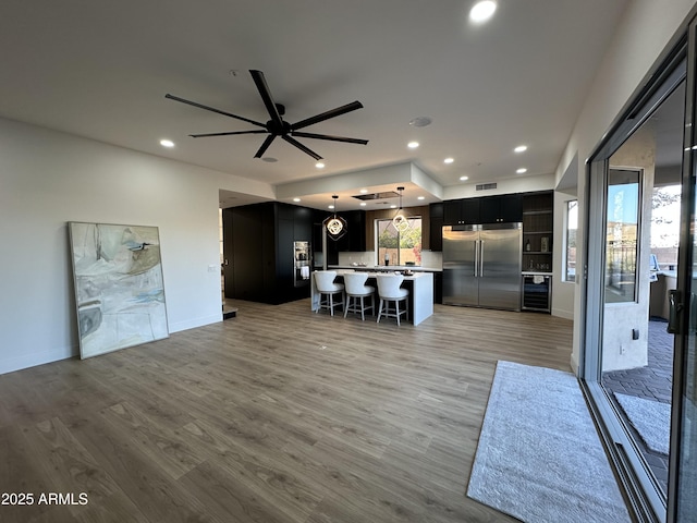 10646 E Butherus Dr, Scottsdale, AZ 85255 - living area with recessed lighting, light wood-style floors, ceiling fan, and baseboards