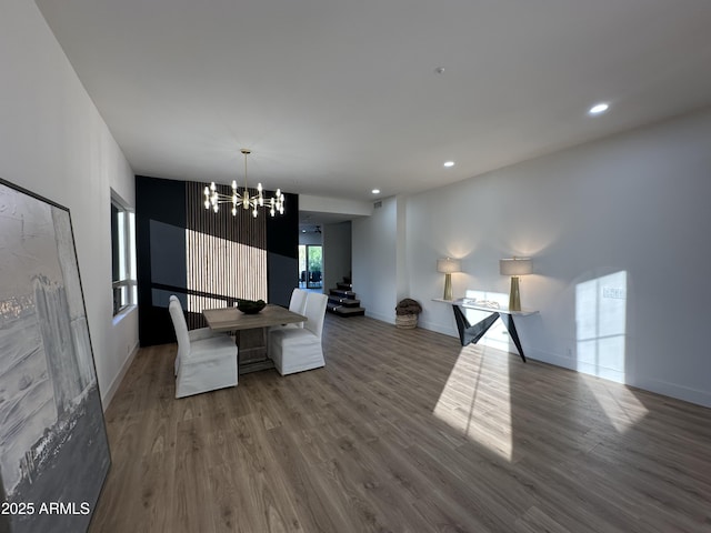 10646 E Butherus Dr, Scottsdale, AZ 85255 - unfurnished dining area with a chandelier, wood finished floors, recessed lighting, baseboards, and stairway