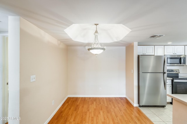 4850 E Desert Cove Ave Unit 240, Scottsdale, AZ 85254 - kitchen featuring white cabinetry, appliances with stainless steel finishes, light wood finished floors, and visible vents