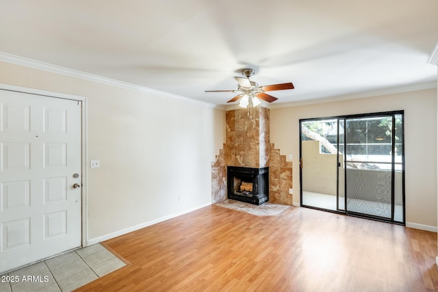 4850 E Desert Cove Ave Unit 240, Scottsdale, AZ 85254 - unfurnished living room with crown molding, a fireplace, baseboards, ceiling fan, and light wood finished floors