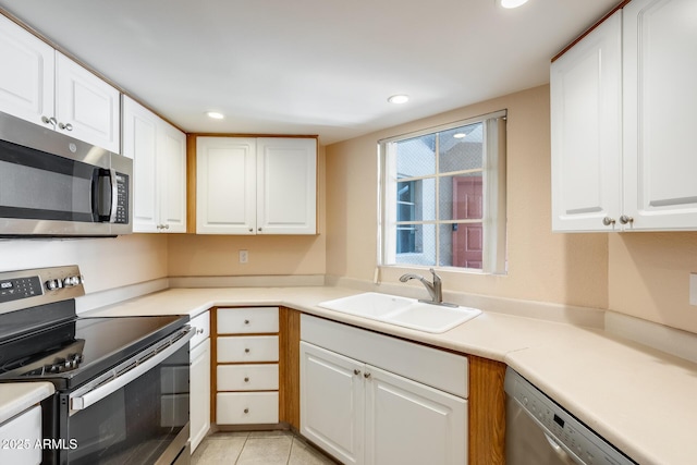 4850 E Desert Cove Ave Unit 240, Scottsdale, AZ 85254 - kitchen with appliances with stainless steel finishes, a sink, light tile patterned floors, recessed lighting, and white cabinetry