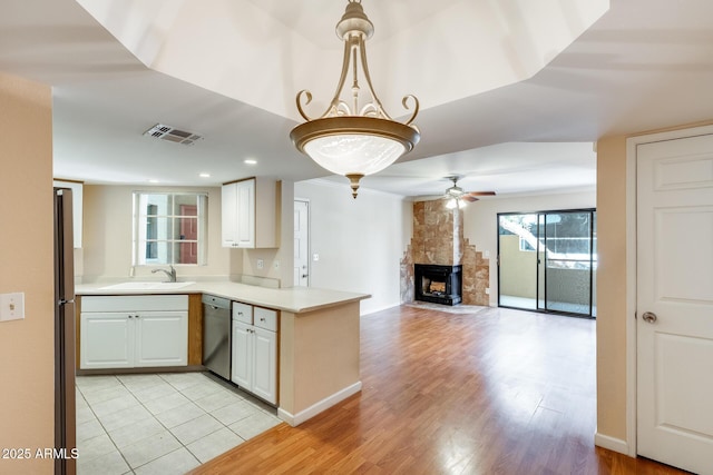 4850 E Desert Cove Ave Unit 240, Scottsdale, AZ 85254 - kitchen with a ceiling fan, visible vents, stainless steel dishwasher, light countertops, and a peninsula