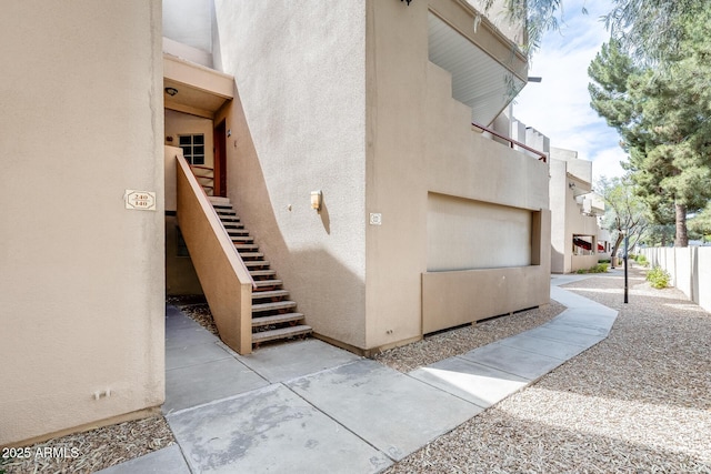 4850 E Desert Cove Ave Unit 240, Scottsdale, AZ 85254 - view of home's exterior with fence, stairs, and stucco siding