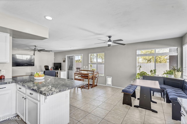 kitchen featuring a healthy amount of sunlight, white cabinets, and open floor plan