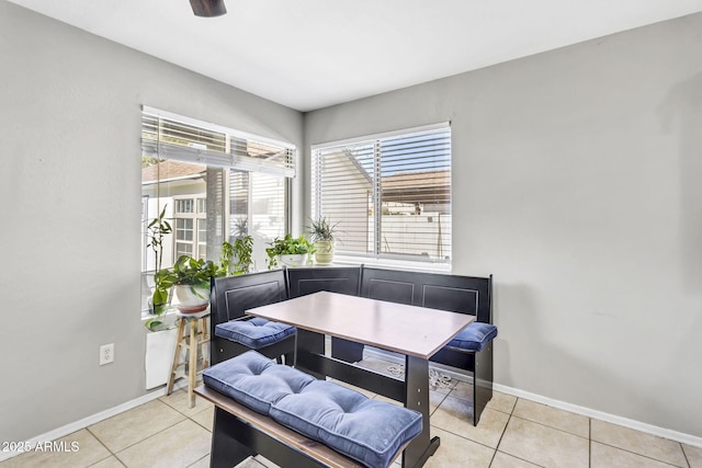 dining room featuring baseboards and light tile patterned floors