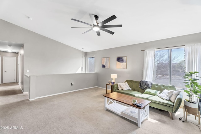 living room with light colored carpet, a healthy amount of sunlight, and vaulted ceiling