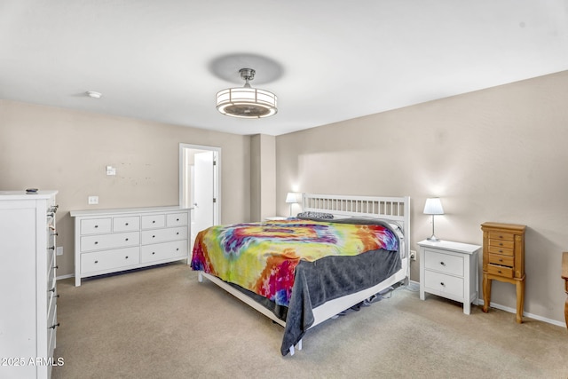 bedroom featuring light colored carpet and baseboards