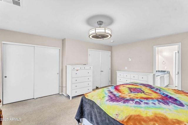 bedroom with connected bathroom and visible vents