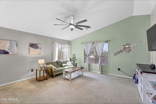 living room with baseboards, vaulted ceiling, a ceiling fan, and light colored carpet