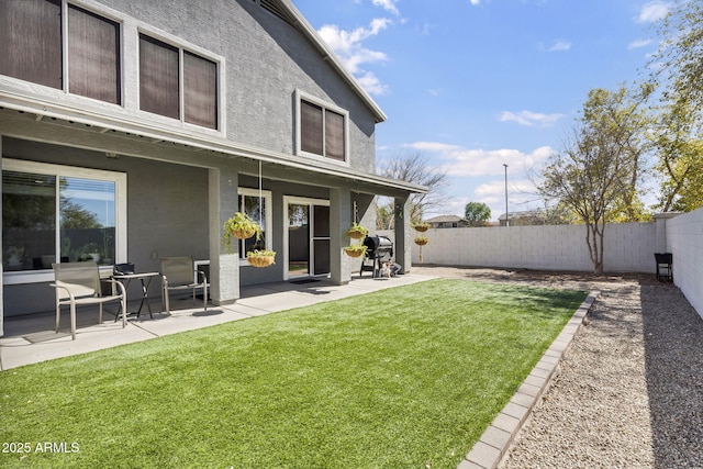 view of yard featuring a patio area and a fenced backyard