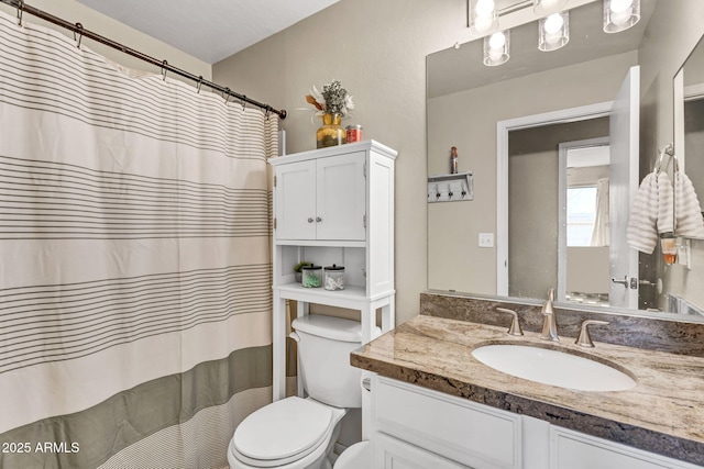 full bathroom featuring toilet and vanity