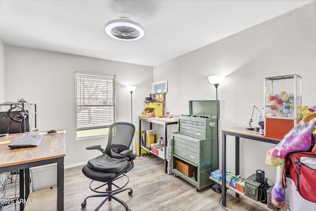 home office with light wood-style floors and baseboards