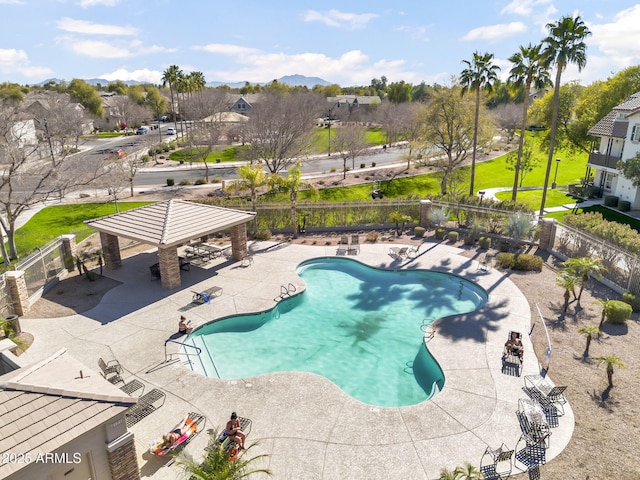 pool featuring a residential view, a patio area, fence, and a gazebo