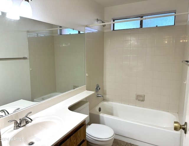 full bathroom with vanity, toilet, and tiled shower / bath combo