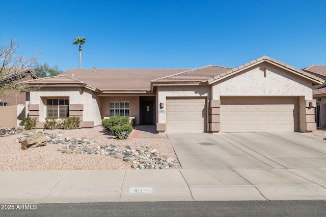 ranch-style home featuring a garage, a tiled roof, concrete driveway, and stucco siding