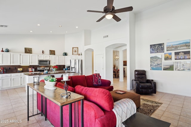 4936 E Villa Rita Dr, Scottsdale, AZ 85254 - living room with high vaulted ceiling, arched walkways, recessed lighting, and light tile patterned floors