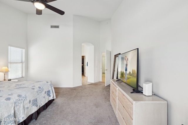 4936 E Villa Rita Dr, Scottsdale, AZ 85254 - bedroom with a towering ceiling, visible vents, arched walkways, and light colored carpet