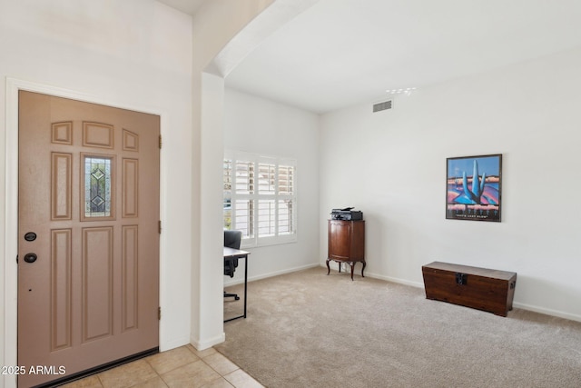 4936 E Villa Rita Dr, Scottsdale, AZ 85254 - carpeted foyer with arched walkways, tile patterned flooring, visible vents, and baseboards