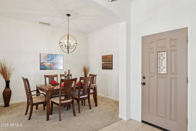 4936 E Villa Rita Dr, Scottsdale, AZ 85254 - dining space with arched walkways, light tile patterned floors, light colored carpet, visible vents, and an inviting chandelier