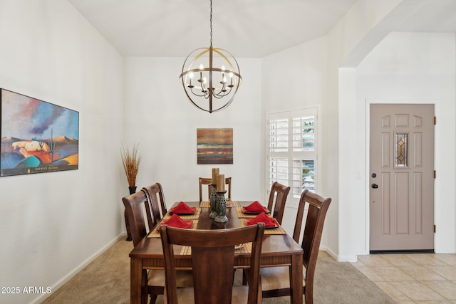 4936 E Villa Rita Dr, Scottsdale, AZ 85254 - dining space featuring light carpet, an inviting chandelier, baseboards, and arched walkways