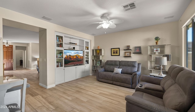 living room featuring light hardwood / wood-style floors and ceiling fan