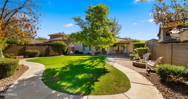 view of yard featuring a patio and an outdoor fire pit