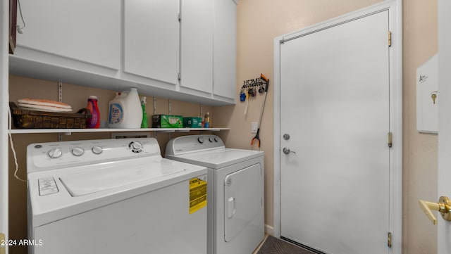 laundry room with cabinets and washer and dryer