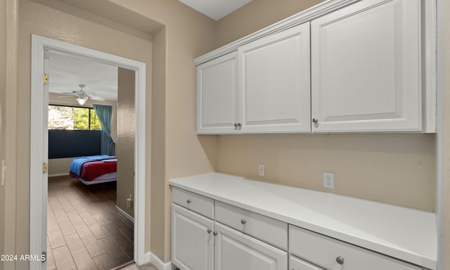 laundry room featuring hardwood / wood-style flooring and ceiling fan