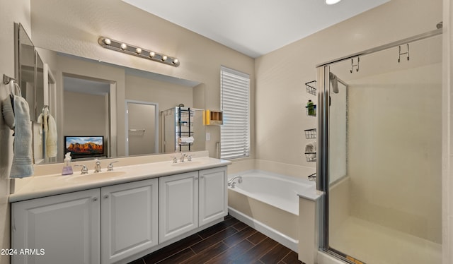 bathroom with vanity, wood-type flooring, and shower with separate bathtub